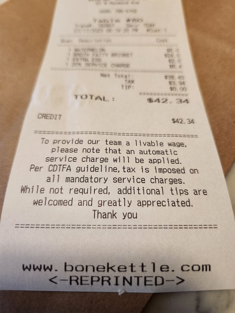 An explanation of the service charge at Bone Kettle in Pasadena.