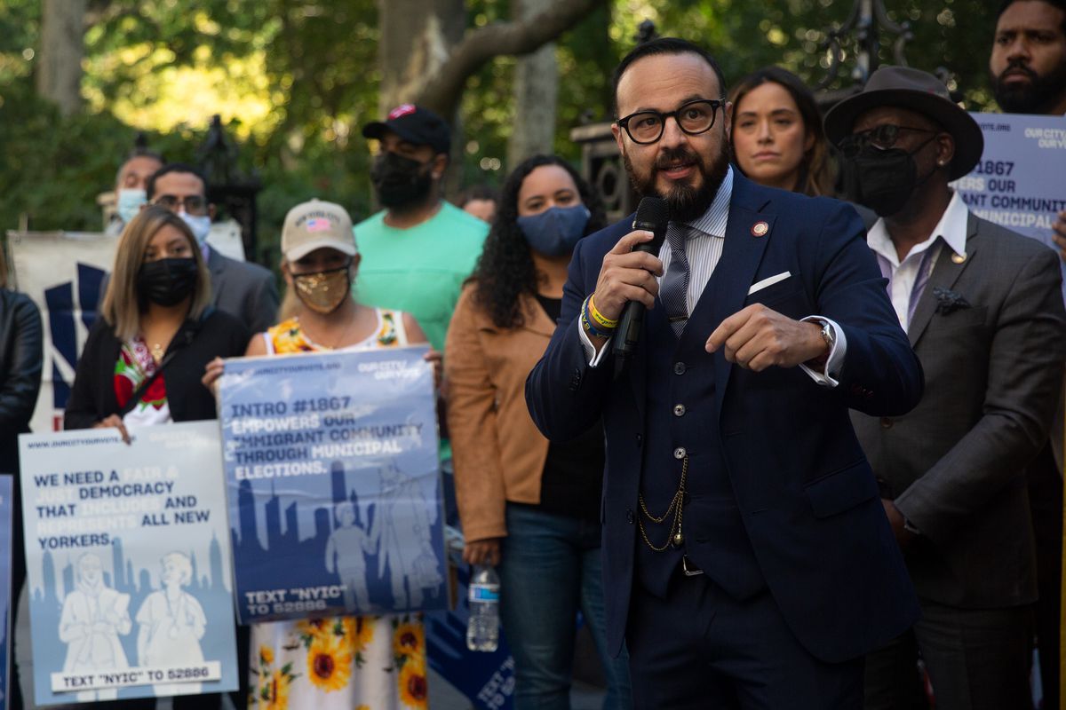 Councilmember Francisco Moya speaks at a rally outside City Hall in support of immigrant voting rights, Oct. 22, 2021.