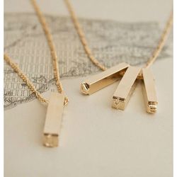 <i><a href="http://ericaweiner.com/collections/erica-weiner-collection-view-all/products/double-letterpress-necklace-gold-plate#.U6ndYaioSKx">Letterpress Necklace</a>, $52 (was $65)</i>