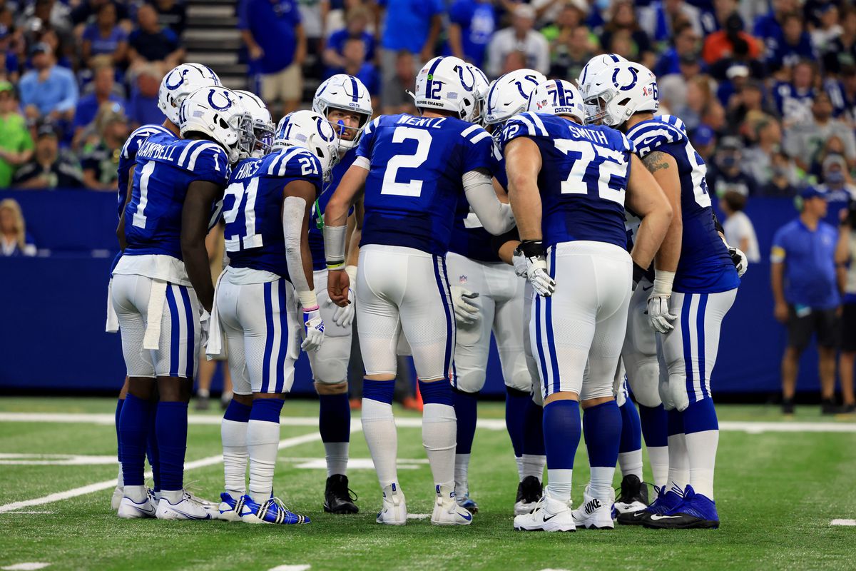 Carson Wentz #2 and the Indianapolis Colts huddle up in the game against the Seattle Seahawks at Lucas Oil Stadium on September 12, 2021 in Indianapolis, Indiana.
