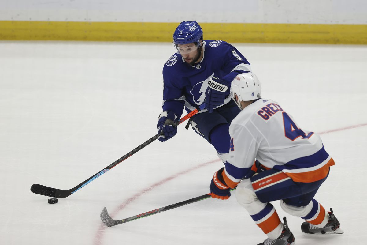 Tampa Bay Lightning center Tyler Johnson (9) skates against New York Islanders defenseman Andy Greene (4) in the third period of Game 5 of the Stanley Cup Playoffs Semifinals between the New York Islanders and Tampa Bay Lightning on June 21, 2021 at Amalie Arena in Tampa, FL.