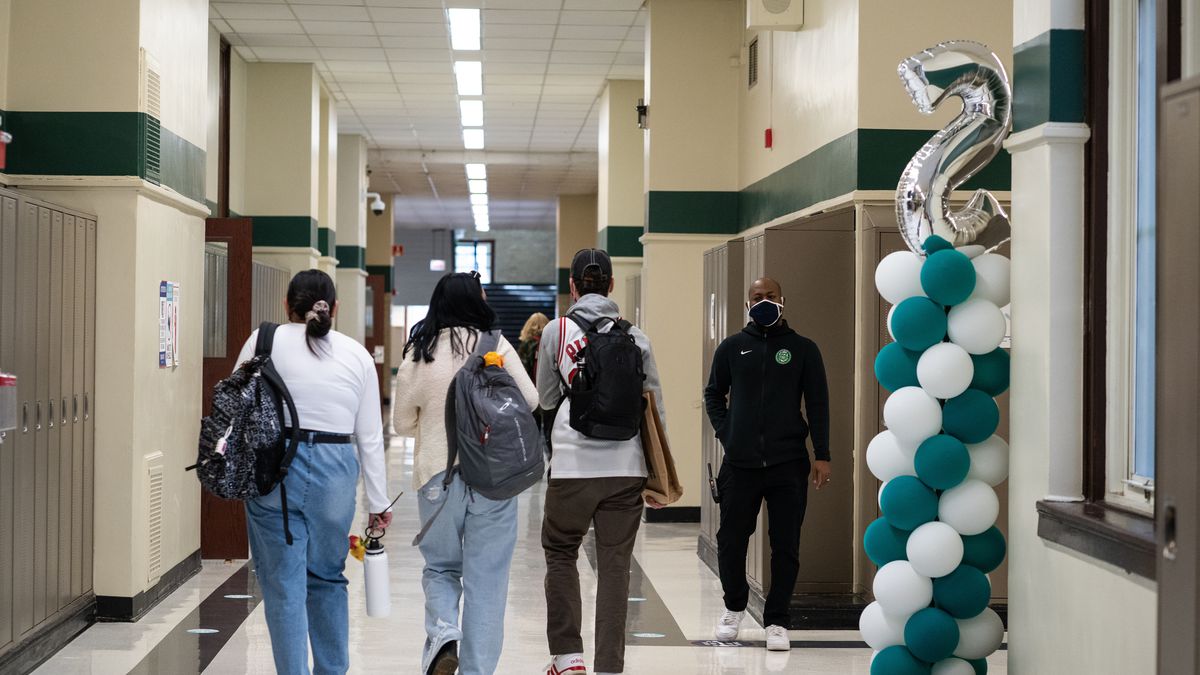 Students walk the halls of Senn High School, which are decorated with balloons, on the first week back to classrooms on April 23, 2021.