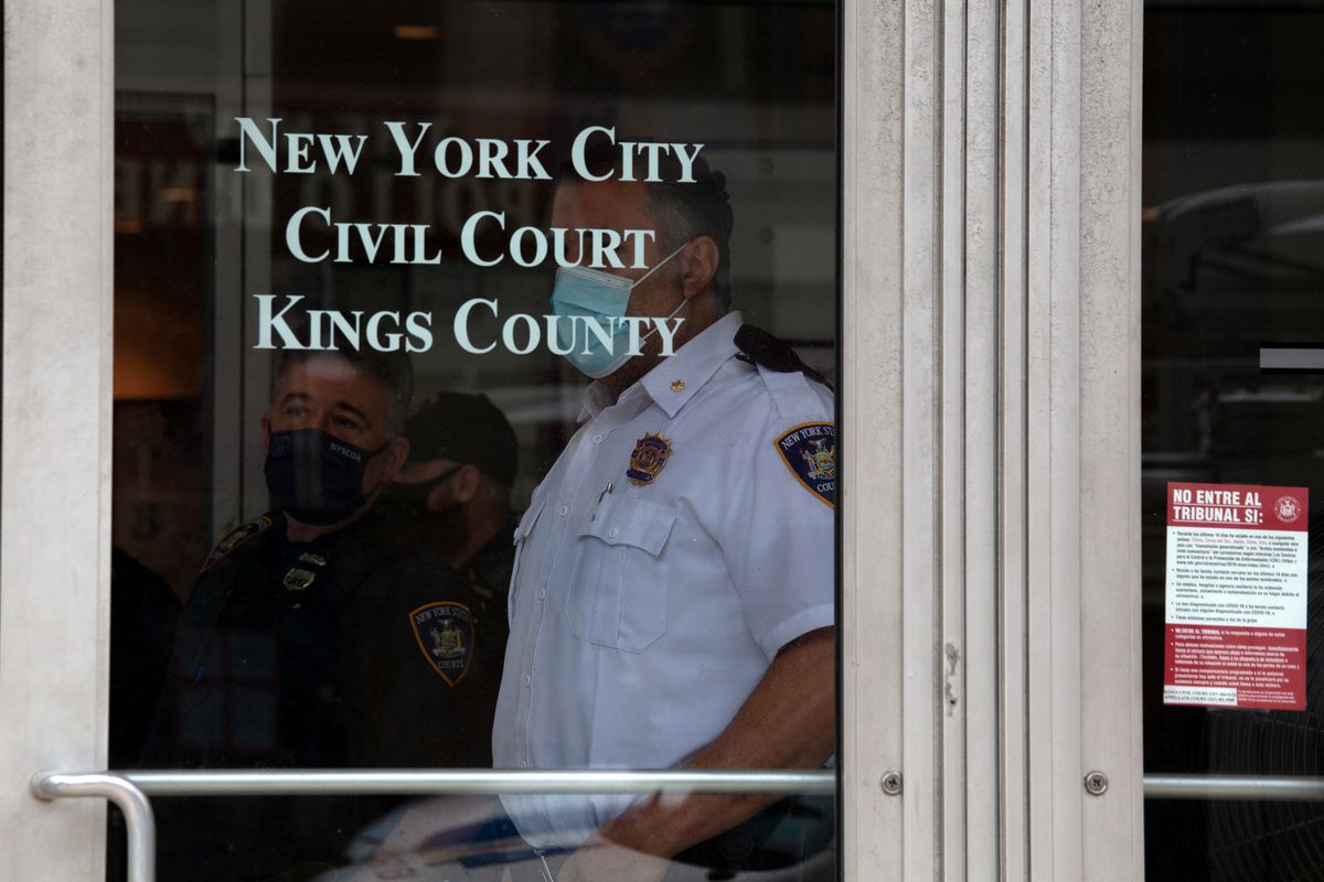 Court officer watch a tenant rights protest outside Brooklyn Housing Court, Aug. 6, 2020.