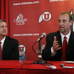 FILE - Michael K. Young President, University of Utah (left) and Dr. Chris Hill
Athletics Director (center left) listen as Larry Krystkowiak (CQ) (right) speaks to the media and boosters Monday, April 4, 2011 at a press conference announcing Krystkowiak as the new men's head basketball coach at the Huntsman Center. 