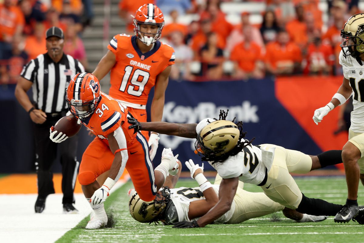 Sean Tucker of the Syracuse Orange is tackled by Cory Trice of the Purdue Boilermakers during the second quarter at JMA Wireless Dome on September 17, 2022 in Syracuse, New York.