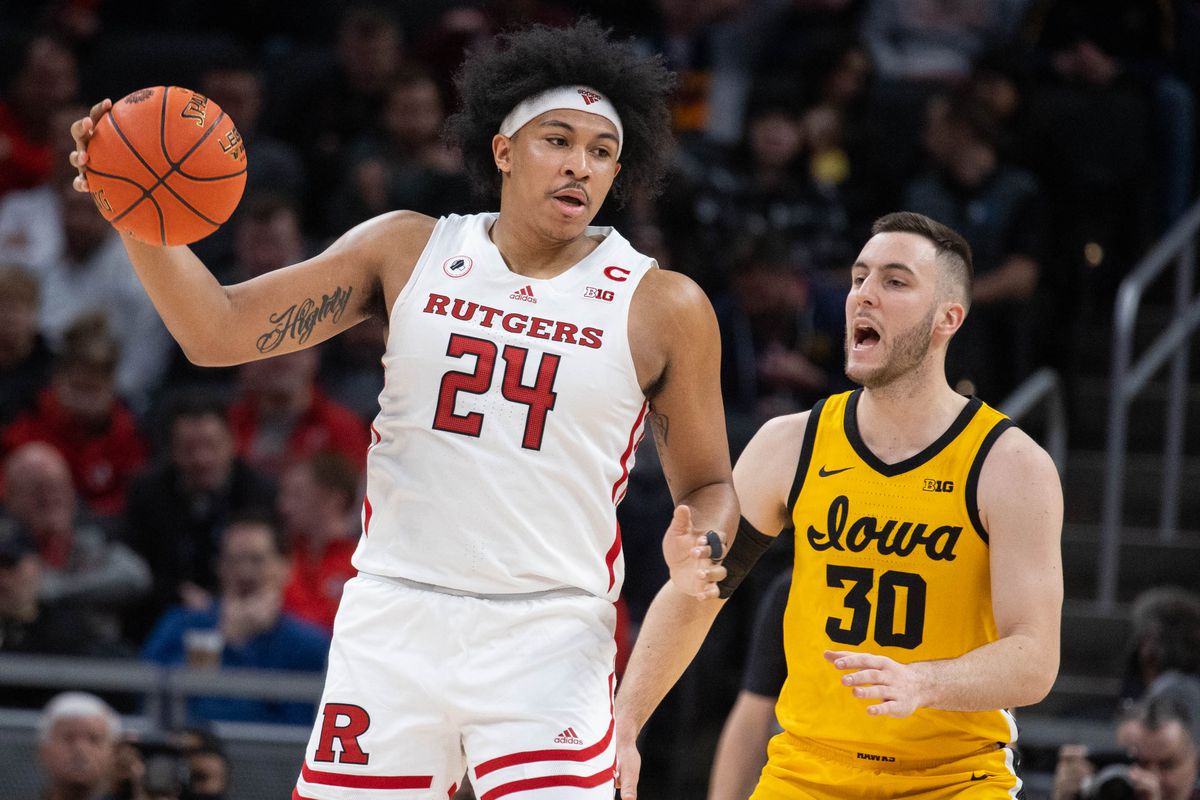 Rutgers Scarlet Knights forward Ron Harper Jr. (24) catches the ball while Iowa Hawkeyes guard Connor McCaffery (30) defends in the first half at Gainbridge Fieldhouse