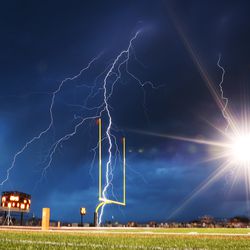 Lightning flashes at halftime as Lone Peak and Herriman open the 2018-19 football season at Lone Peak on Friday, Aug. 17, 2018. The game was delayed at the half for weather.