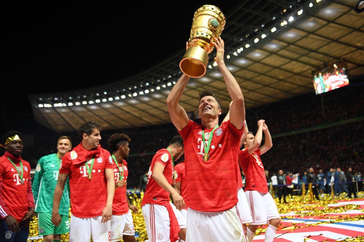 BERLIN, GERMANY - MAY 25: Robert Lewandowski of Bayern Munich celebrates victory with the trophy after the DFB Cup final between RB Leipzig and Bayern Muenchen at Olympiastadion on May 25, 2019 in Berlin, Germany.