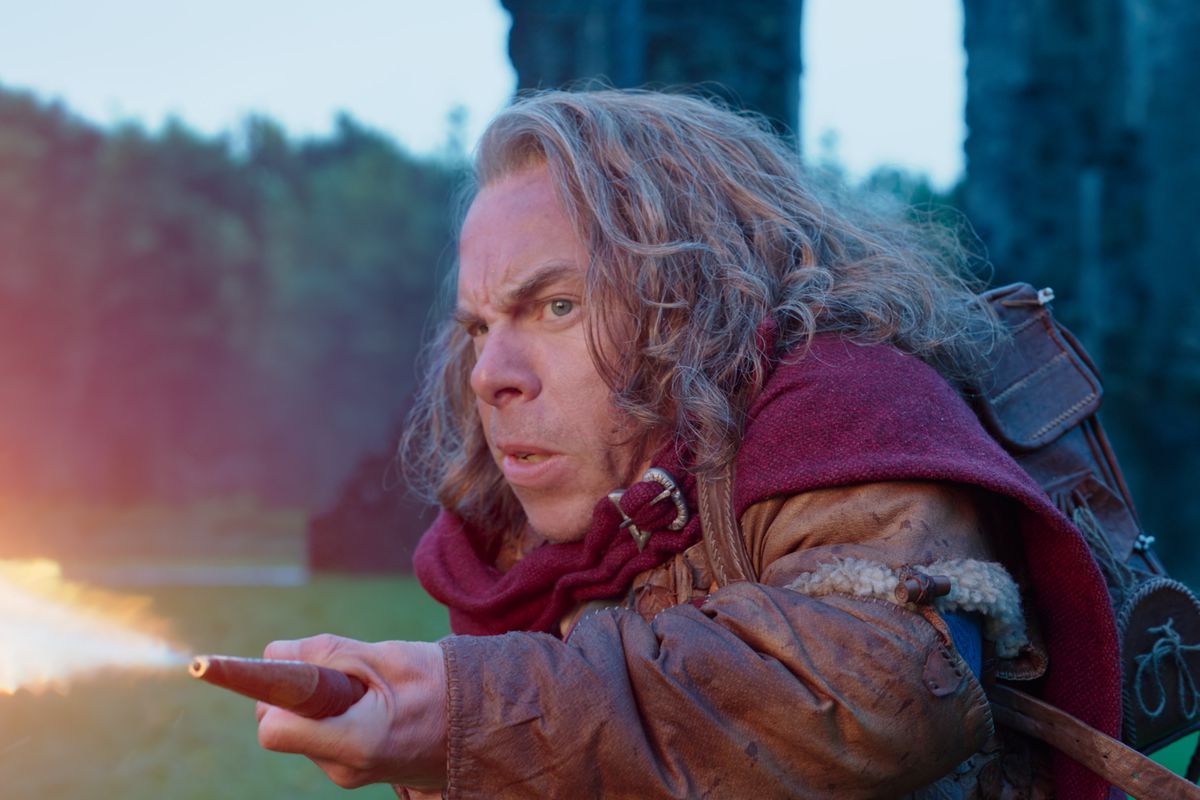 Willow Ufgood (Warwick Davis) shoots fire from a magical flamethrower in Lucasfilm’s WILLOW