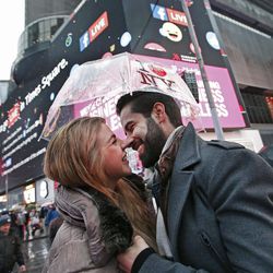 Tourists Isabella Zuniga, left, and Kalid Magana of San Luis Potosi, Mexico, share an intimate moment while visiting Times Square, Thursday, Dec. 29, 2016, in New York. Police say they are up to the task of protecting the huge crowds that are expected to fill Times Square for New York City's massive New Year's Eve celebration. 