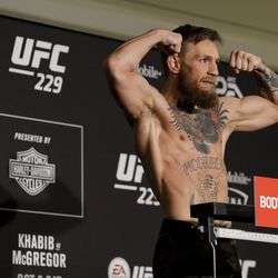 Conor McGregor poses after making weight at UFC 229 weigh-ins.