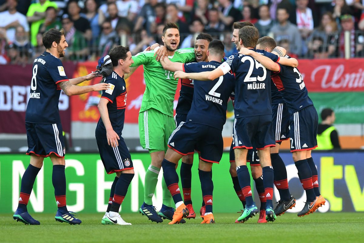 Bayern Munich players celebrate after the German first division Bundesliga football match 1 FC Augsburg vs FC Bayern Munich in Augsburg, southern Germany, on April 7, 2018.
