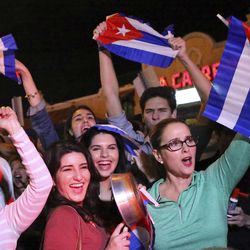 FILE- In this Nov. 25, 2016, file photo, the Cuban community in Miami celebrates the announcement that Fidel Castro died in front La Carreta Restaurant early in Miami. For the hundreds of thousands of children born of Cuban exiles, some who are two and three generations removed from the island, Fidel Castro’s death potentially opens a door to a world previously off-limits. 