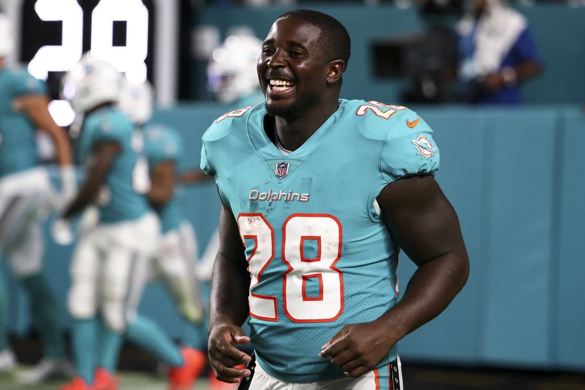 Sony Michel #28 of the Miami Dolphins smiles during a preseason NFL football game against the Las Vegas Raiders at Hard Rock Stadium on August 20, 2022 in Miami Gardens, Florida.