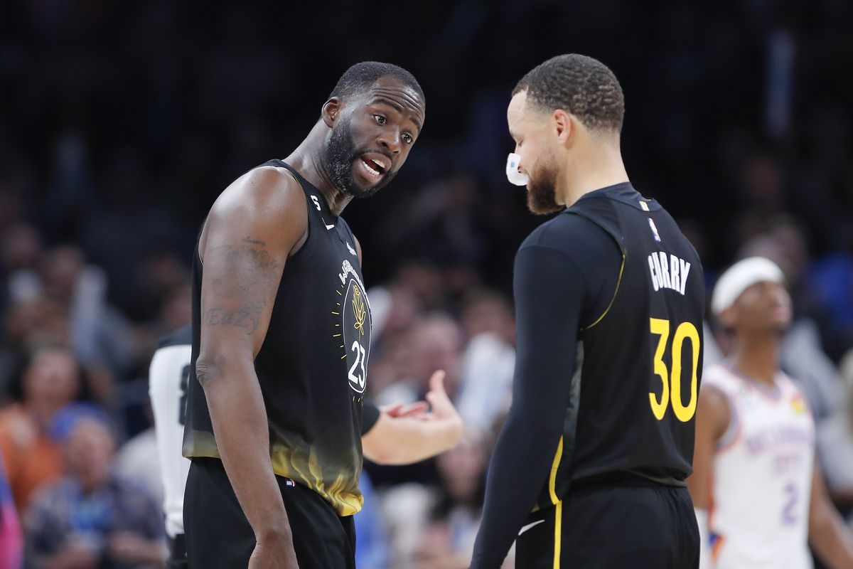 Steph Curry and Draymond Green looking at each other in disbelief 