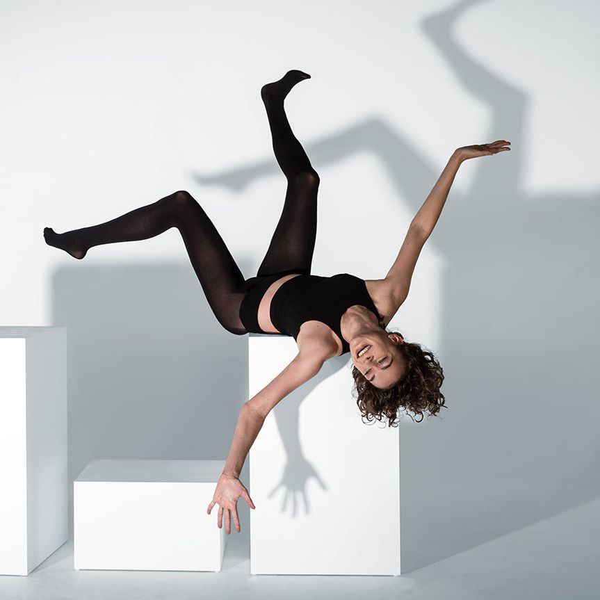 A woman stretches out in Heist tights