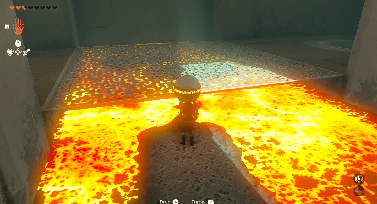 Link riding a stone down a river of fire, holding a ball, in The Legend of Zelda: Tears of the Kingdom’s Timawak Shrine