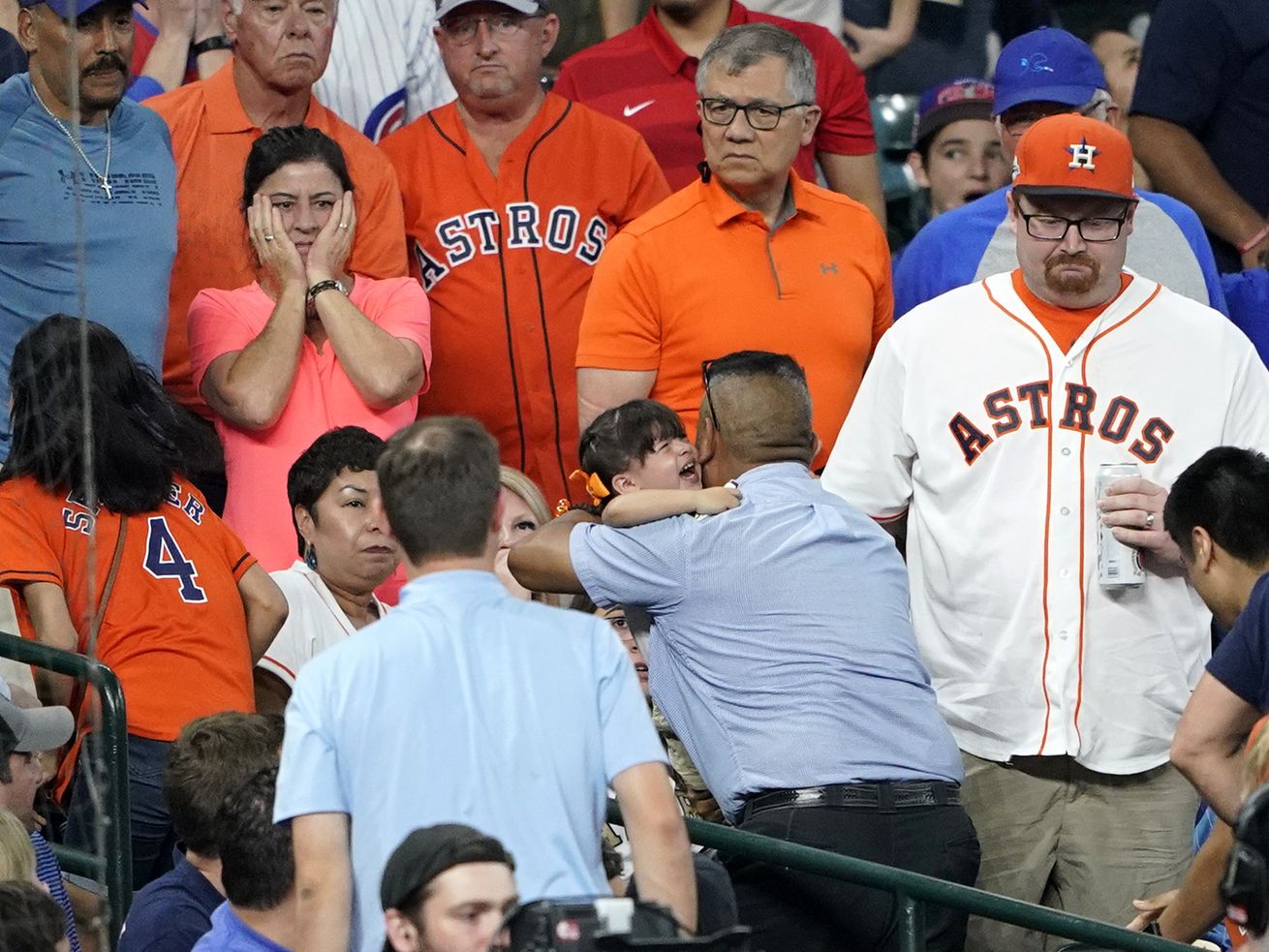 A young child is carried from the stands after being injured by a foul ball off the bat of Chicago Cubs’ Albert Almora Jr. during the fourth inning of a baseball game against the Houston Astros Wednesday, May 29, 2019, in Houston. (AP Photo/David J. Phillip)