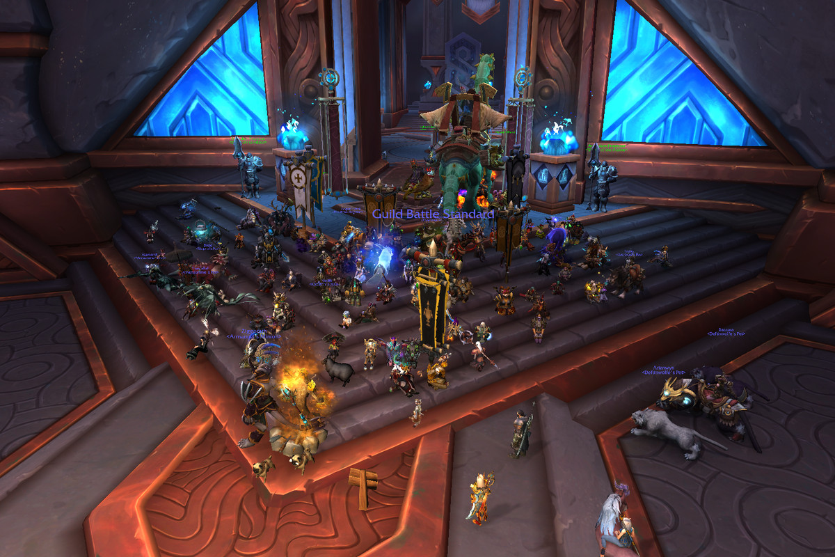 World of Warcraft - a shot of dozens of players sitting together in the Shadowlands city of Oribos for an in-game sit-in protest