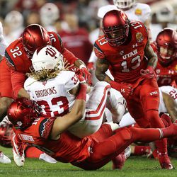 Utah Utes linebacker Sharrieff Shah Jr. (32) and DUPLICATE***Utah Utes defensive back Jason Thompson (10) bring down Indiana Hoosiers running back Ricky Brookins (33)  as the Utes and the Hoosiers play in the Foster Farms Bowl in Santa Clara, California on Wednesday, Dec. 28, 2016.