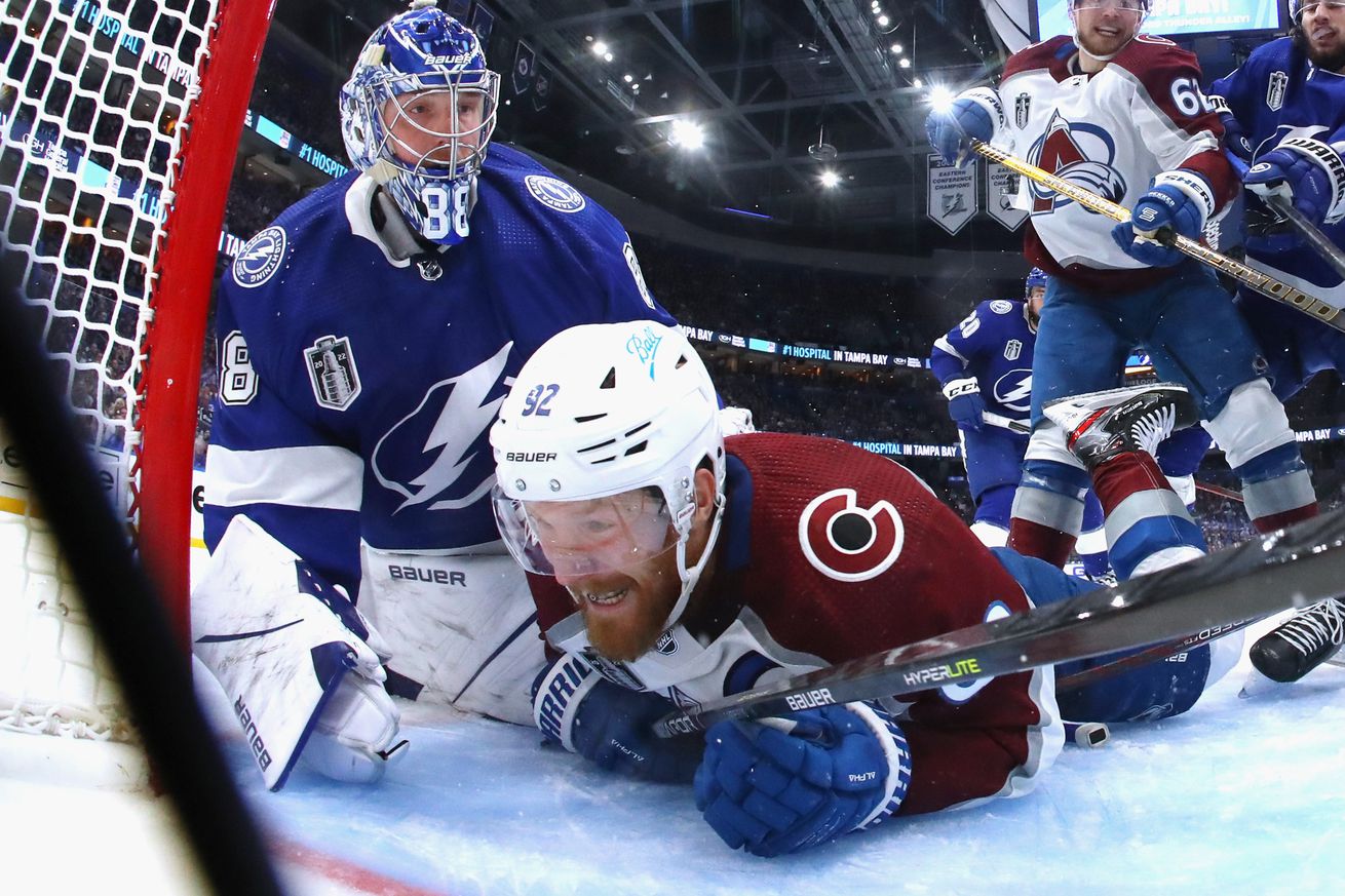 Gabriel Landeskog #92 of the Colorado Avalanche gets tangled up with Andrei Vasilevskiy #88 of the Tampa Bay Lightning during Game 3 of the 2022 NHL Stanley Cup Final at Amalie Arena on June 20, 2022 in Tampa, Florida.