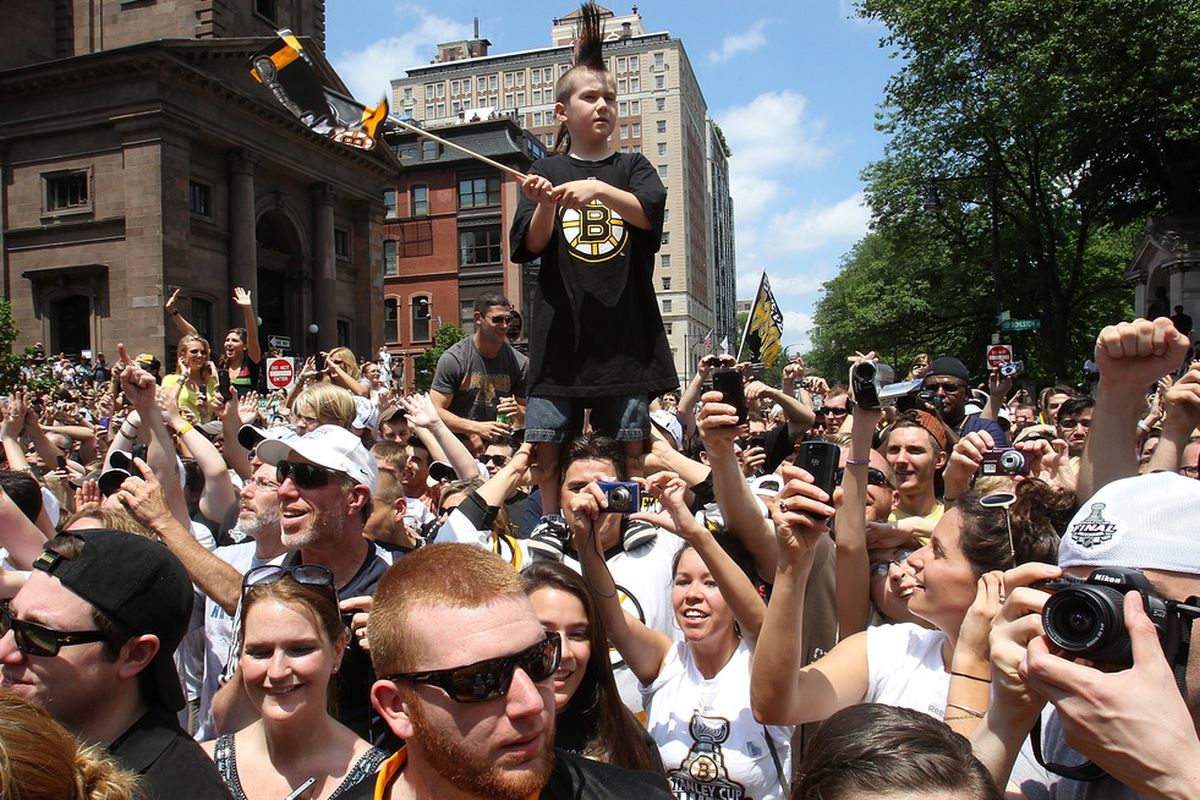 BOSTON, MA  - JUNE 18:  Fans of the Boston Bruins react during a Stanley Cup victory parade on June 18, 2011 in Boston, Massachusetts.  (Photo by Jim Rogash/Getty Images)