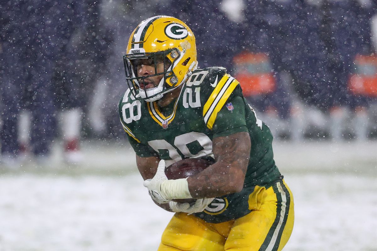 AJ Dillon #28 of the Green Bay Packers runs with the ball in the second quarter against the Tennessee Titans at Lambeau Field on December 27, 2020 in Green Bay, Wisconsin.