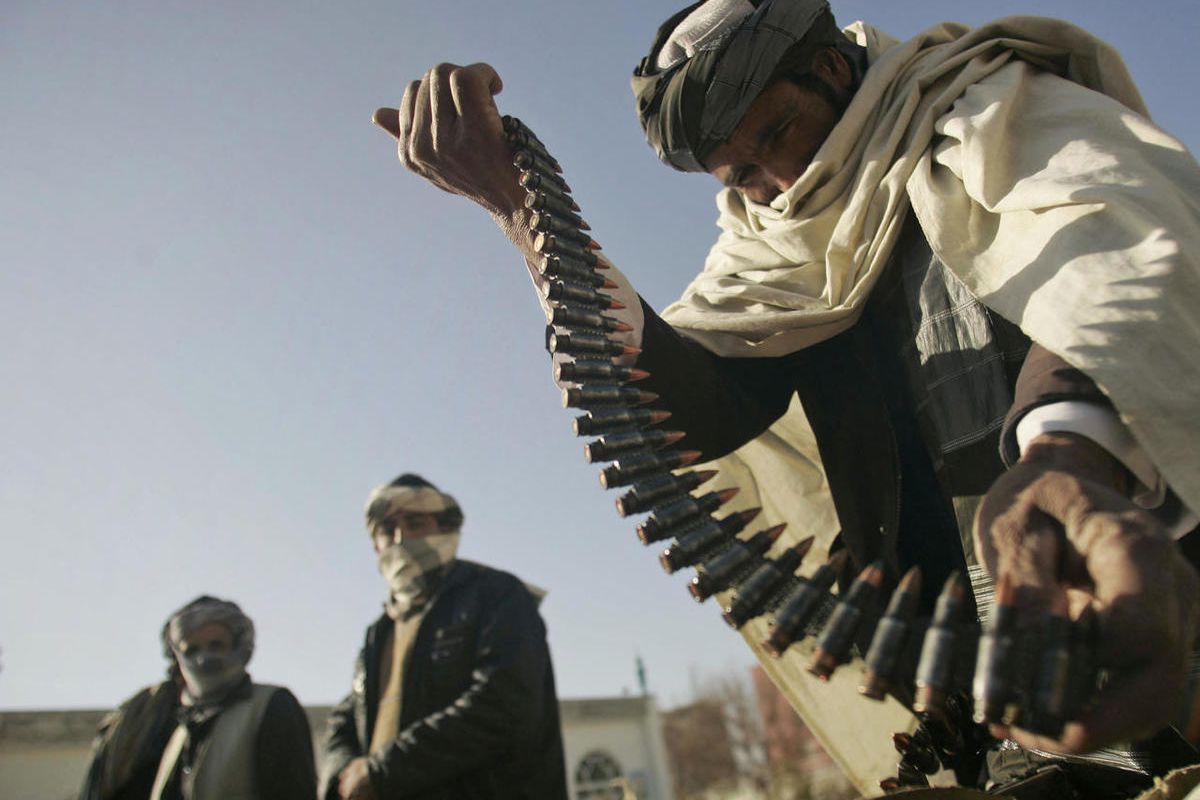 In this Dec. 28, 2011 file photo, a former Taliban fighter places a range of bullets before surrendering it to Afghan authorities, as part of a peace-reconciliation program in Herat, west of Kabul, Afghanistan. After more than a decade of warfare, negotia