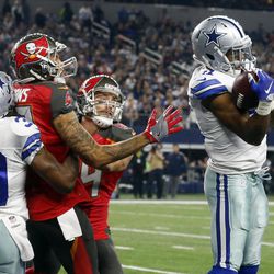 Dallas Cowboys' Brandon Carr (39) helps defend as Byron Jones, right, intercepts a pass intended for Tampa Bay Buccaneers' Mike Evans, center left, in the first half of an NFL football game, Sunday, Dec. 18, 2016, in Arlington, Texas. 