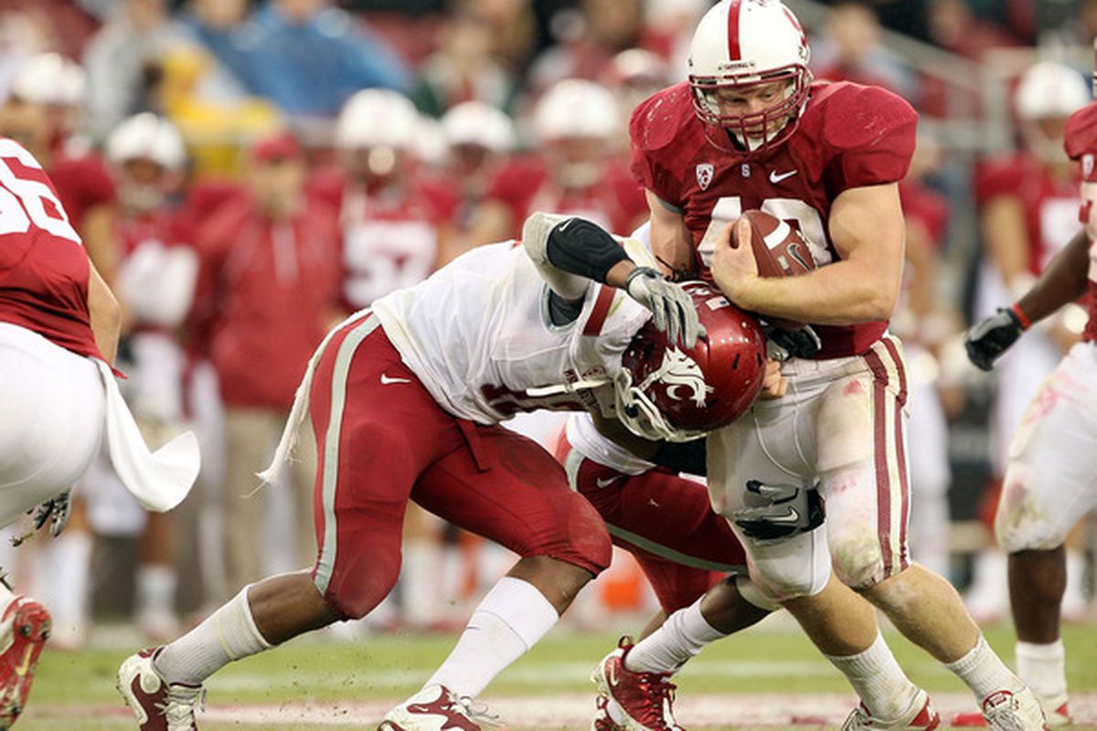 PALO ALTO CA - Owen Marecic #48 of the Stanford Cardinal is tackled by C.J. Mizell #12 of the Washington State Cougars at Stanford Stadium in Palo Alto California.  (Photo by Ezra Shaw/Getty Images)