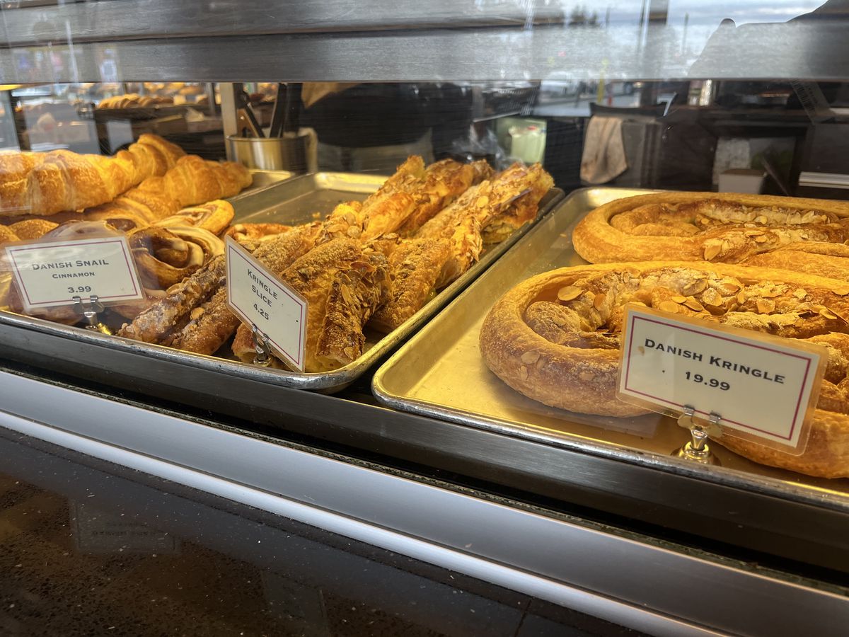 A pastry case containing Danish pastries.
