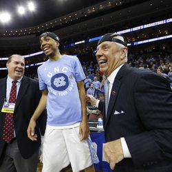 North Carolina's Brice Johnson, center, celebrates with head coach Roy Williams, right, after winning a regional final men's college basketball game against Notre Dame in the NCAA Tournament, Sunday, March 27, 2016, in Philadelphia. North Carolina won 88-74 to advance to the Final Four. (AP Photo/Chris Szagola)