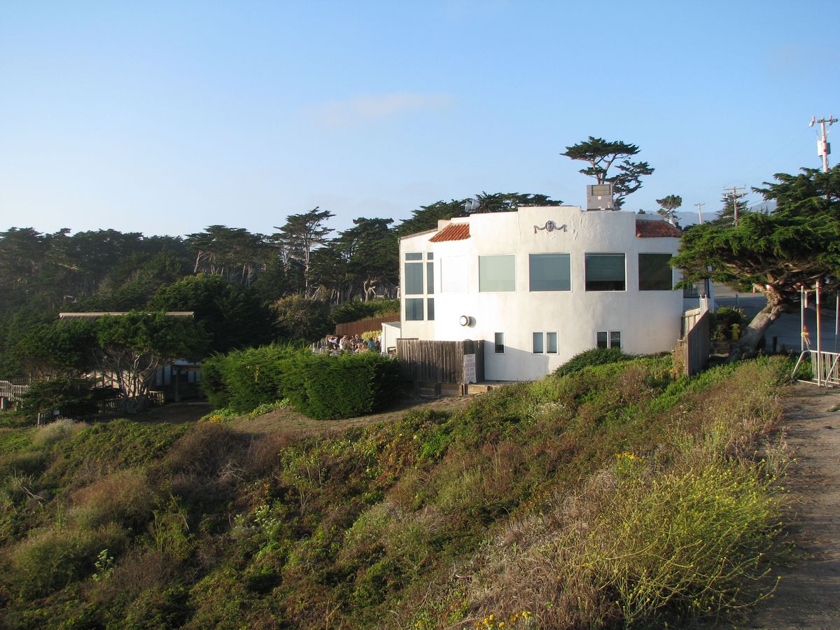 A white building on a hill. 