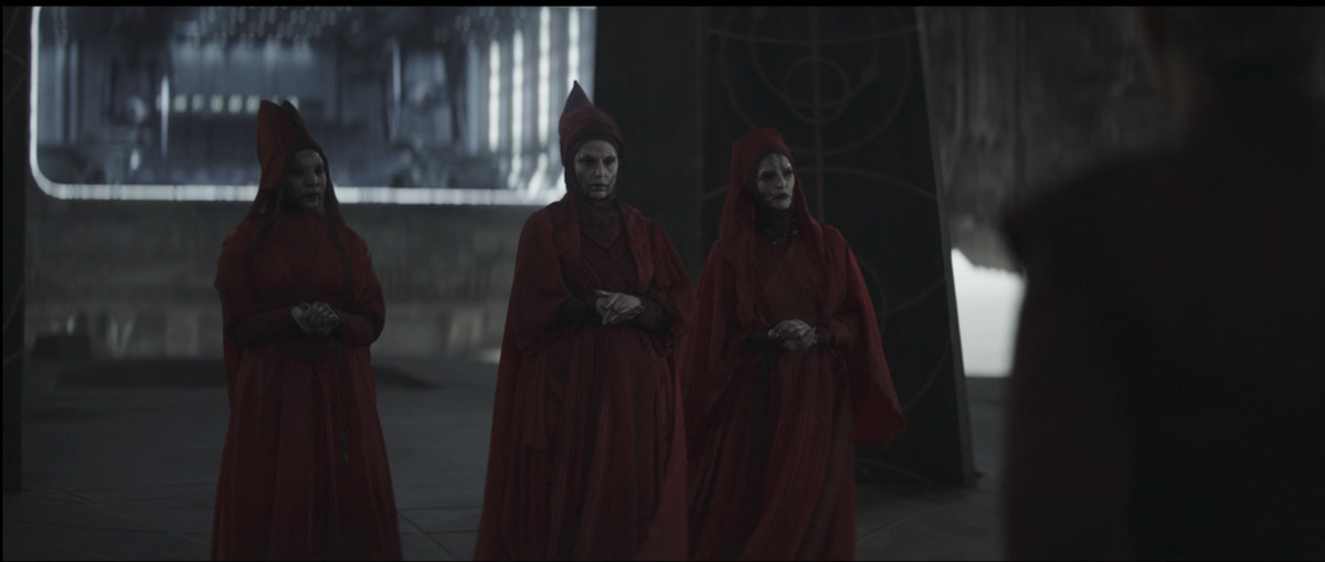 The three Witches of Dathomir standing together with their hands clasped