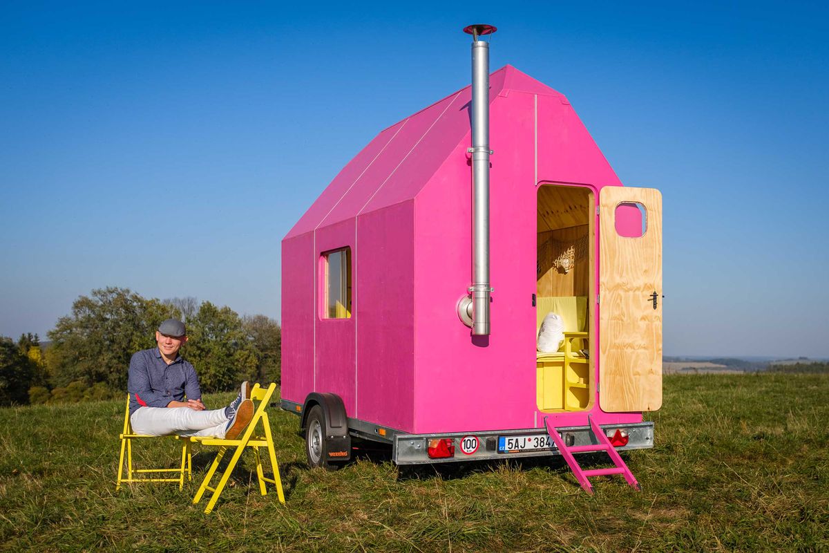 Bright pink small home in field