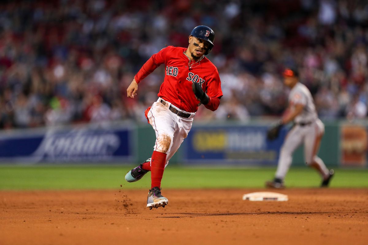 Boston Red Sox right fielder Mookie Betts rounds second base to score the game winning run on a hit by third baseman Rafael Devers against the Baltimore Orioles during the ninth inning at Fenway Park.