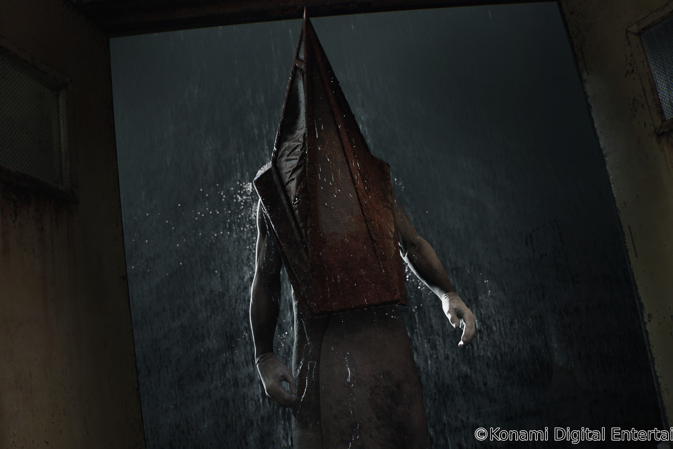 Screenshot from Silent Hill 2 featuring Pyramid Head standing in a door frame.