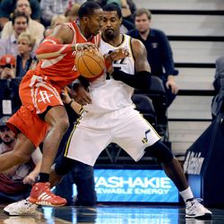Houston Rockets power forward Dwight Howard (12) works his way to the basket as Utah Jazz power forward Derrick Favors (15) defends during a game at EnergySolutions Arena on Monday, Dec. 2, 2013.