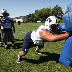 From left, Tyson Brook, Simote Vea and Romney Fuga practice with the BYU football team at BYU in Provo on Saturday, Aug. 4, 2012. Romney's brother Teancum Fuga committed to BYU Wednesday.