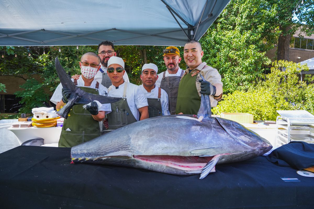 Manabu “Hori” Horiuchi and his team pose for a photo amid breaking down a tuna at the 2022 Southern Smoke Festival.