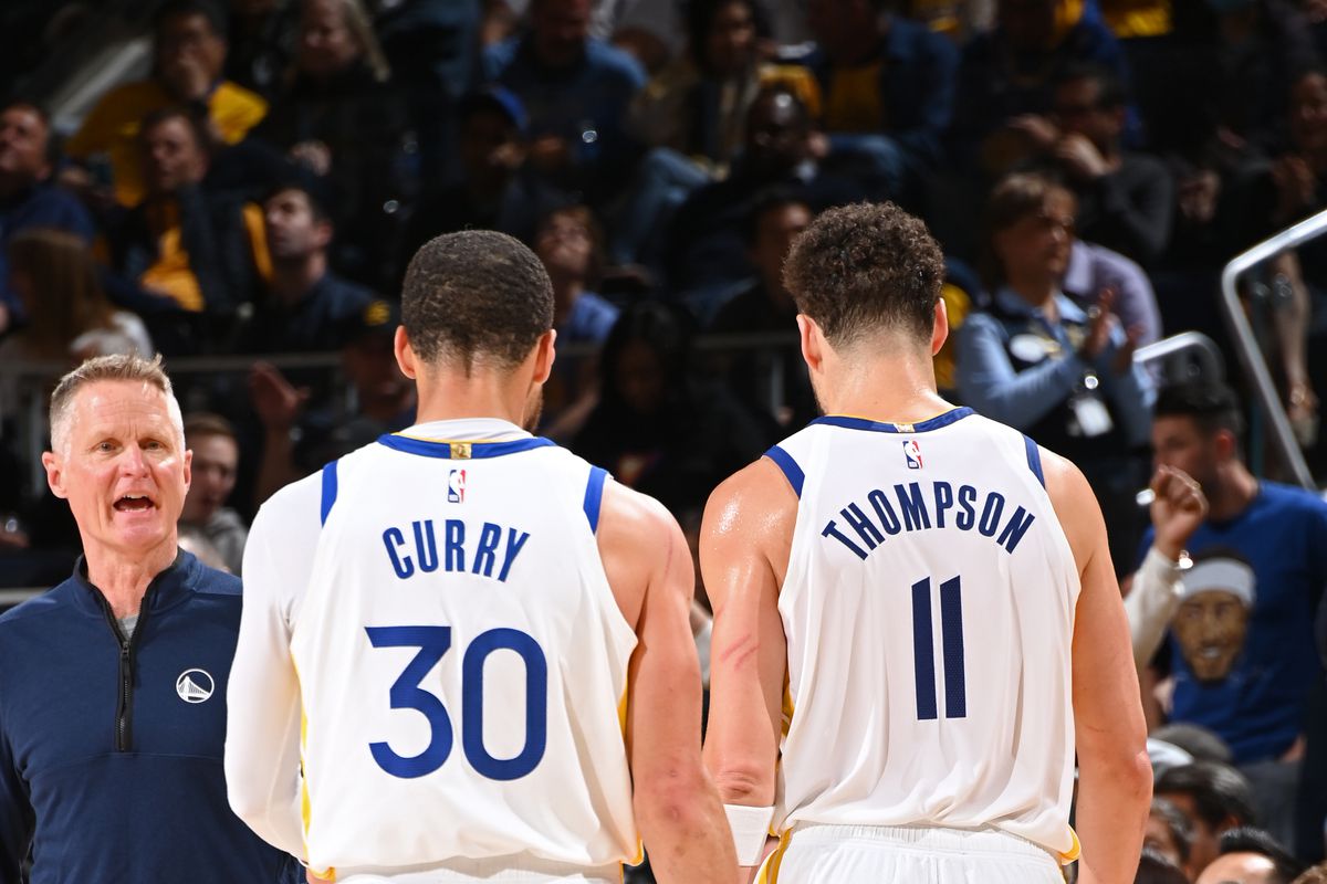 View from behind as Steph Curry and Klay Thompson walk off the court