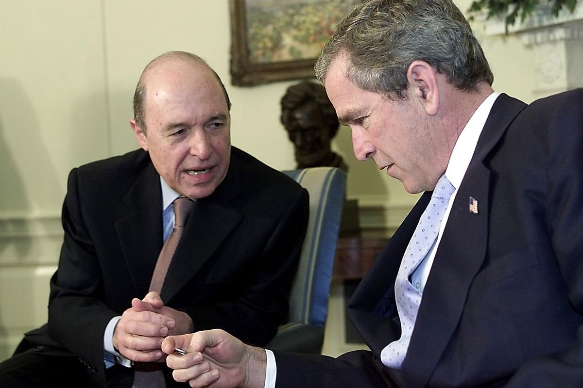 Greek prime minister Costas Simitis shows US president George W. Bush a new euro coin in 2002, six years before the euro began to destroy the Greek economy.