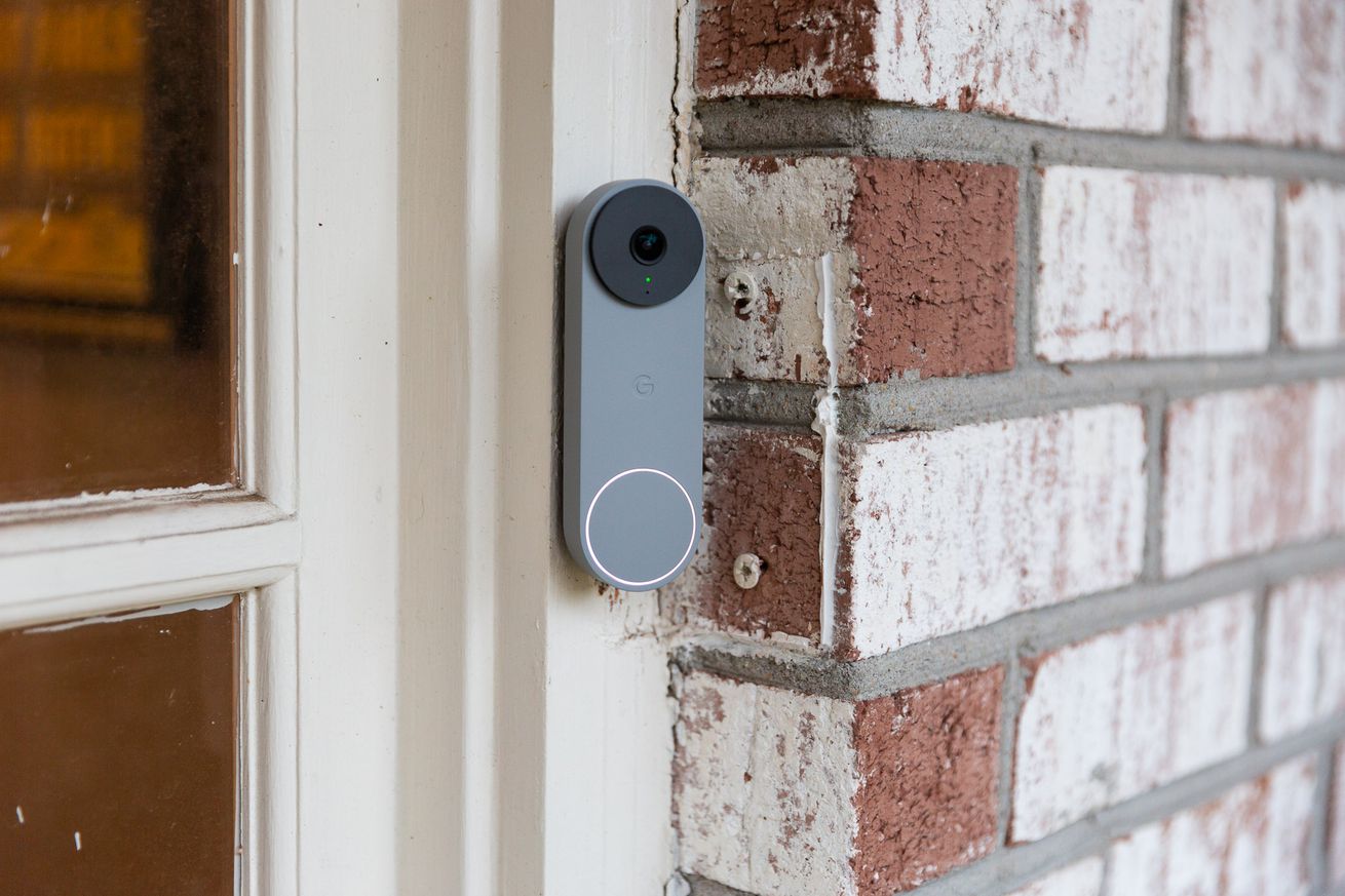 A gray Nest Doorbell on a brick wall
