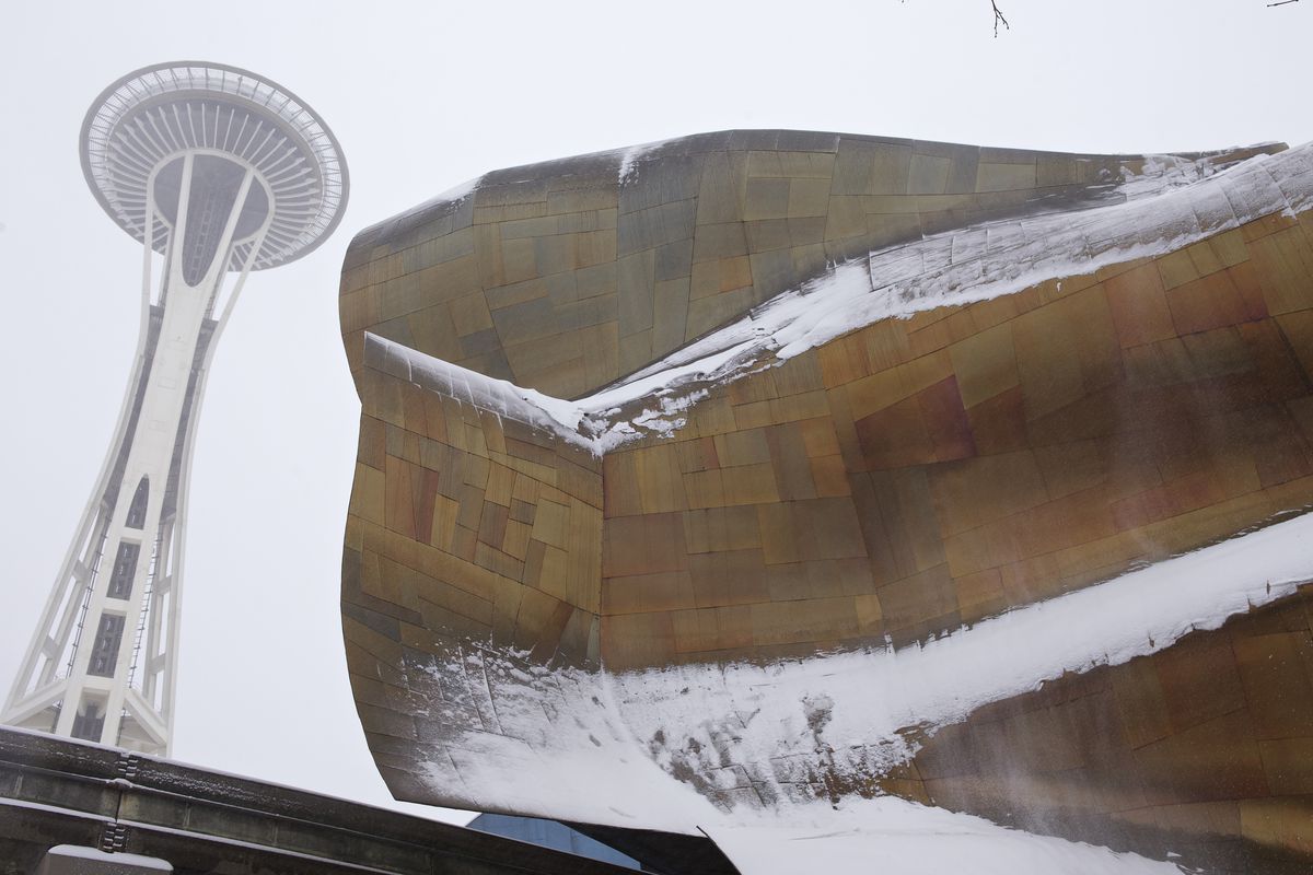 The Space Needle viewed from below, with EMP (a bendy wall of metal) in the foreground to the right