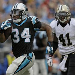 Carolina Panthers' DeAngelo Williams (34) runs past New Orleans Saints' Roman Harper (41) for a touchdown in the first half of an NFL football game in Charlotte, N.C., Sunday, Dec. 22, 2013. 