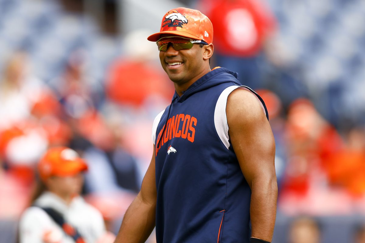 Russell Wilson #3 of the Denver Broncos smiles during warmups before the game against the New York Jets at Empower Field At Mile High on October 23, 2022 in Denver, Colorado.