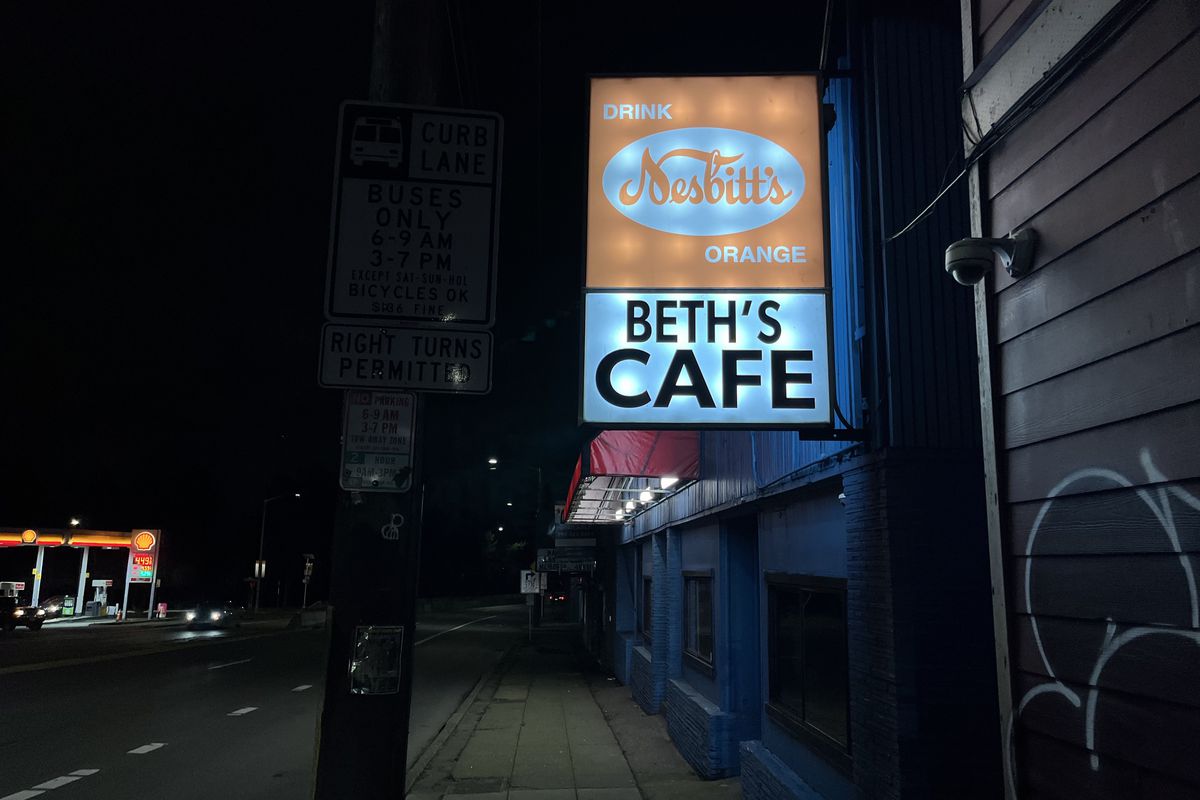 The Beth’s Cafe sign at night.