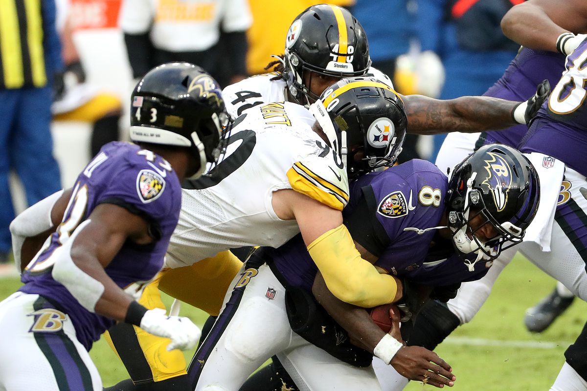 Outside linebacker T.J. Watt #90 of the Pittsburgh Steelers tackles quarterback Lamar Jackson #8 of the Baltimore Ravens during the third quarter at M&amp;T Bank Stadium on November 01, 2020 in Baltimore, Maryland.