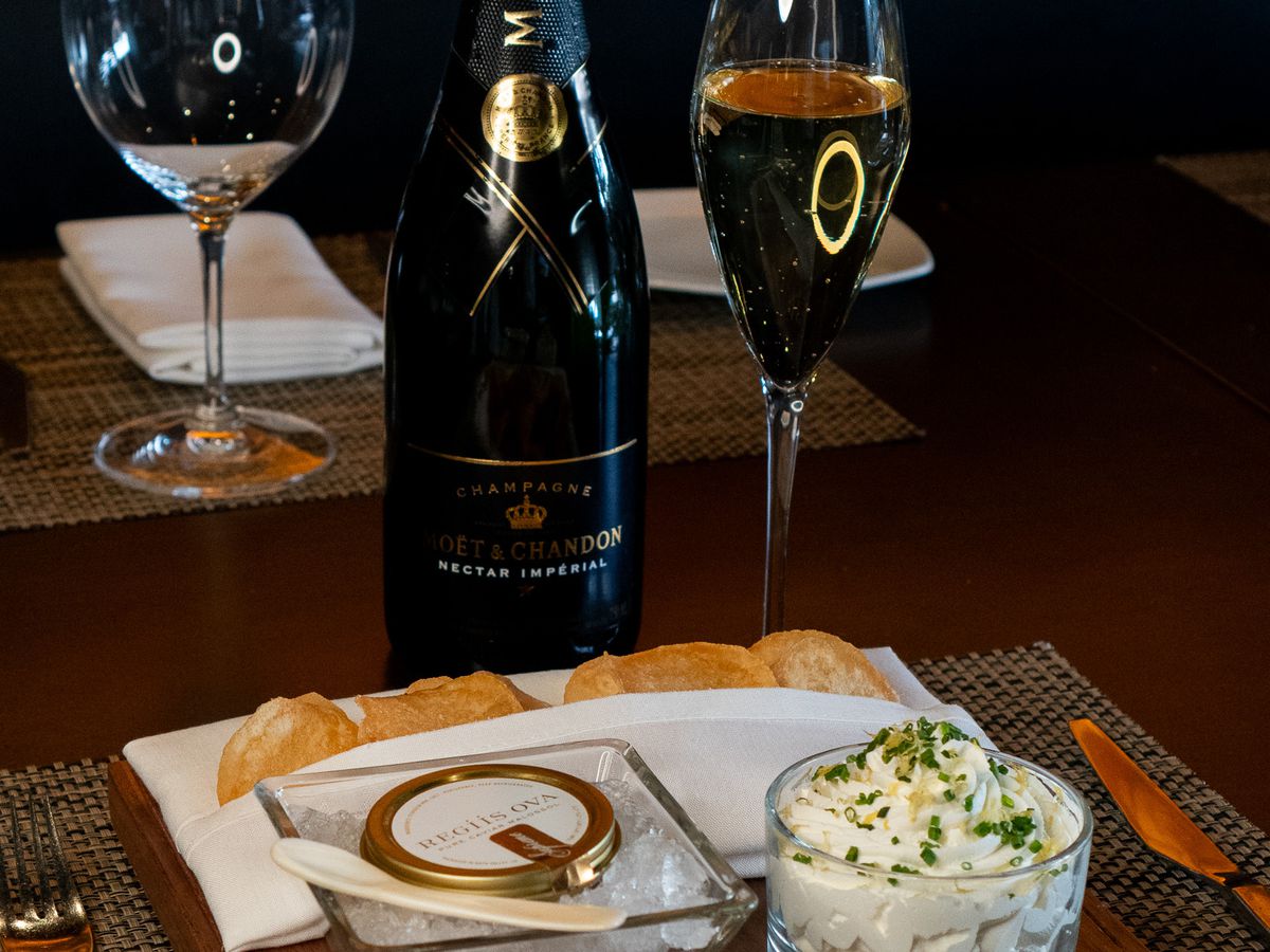Bottle of Moet &amp; Chandon champagne with caviar.