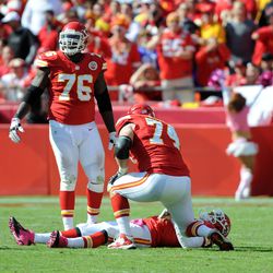 Kansas City Chiefs quarterback Matt Cassel (7) is looked at by tackles Branden Albert (76) and Eric Winston (74) after an injury against the Baltimore Ravens in the second half at Arrowhead Stadium. Baltimore won the game, 9-6.